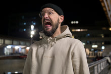 Load image into Gallery viewer, Stefan Kuhnigk wearing the thecoffeemonsters &quot;19 &quot;Angry Chicken&quot; crema standard hoodie&quot; at night in a carpark, screaming for fun.
